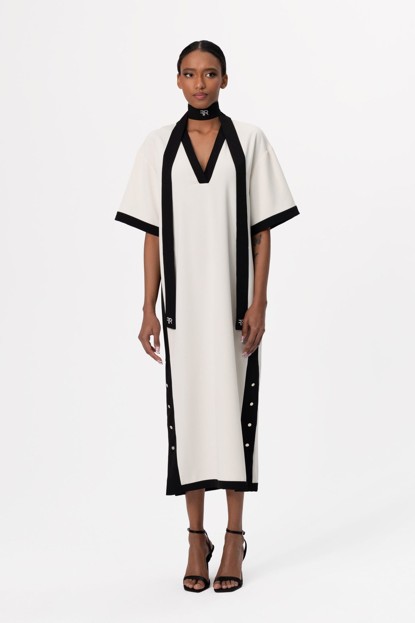 Discover the perfect harmony of contemporary elegance and sophisticated allure with Freisi Milk Color V-Neck Dress