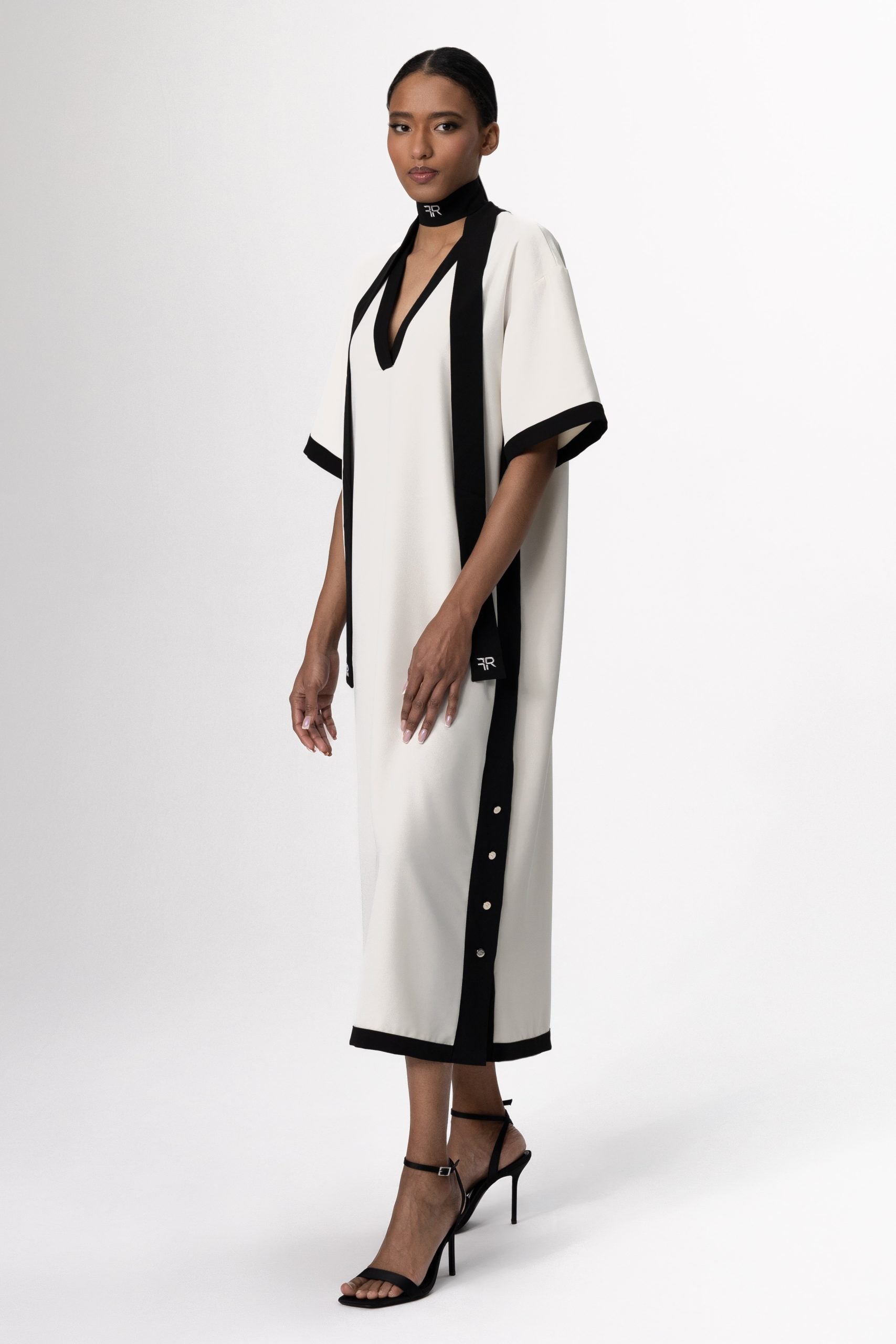 Discover the perfect harmony of contemporary elegance and sophisticated allure with Freisi Milk Color V-Neck Dress