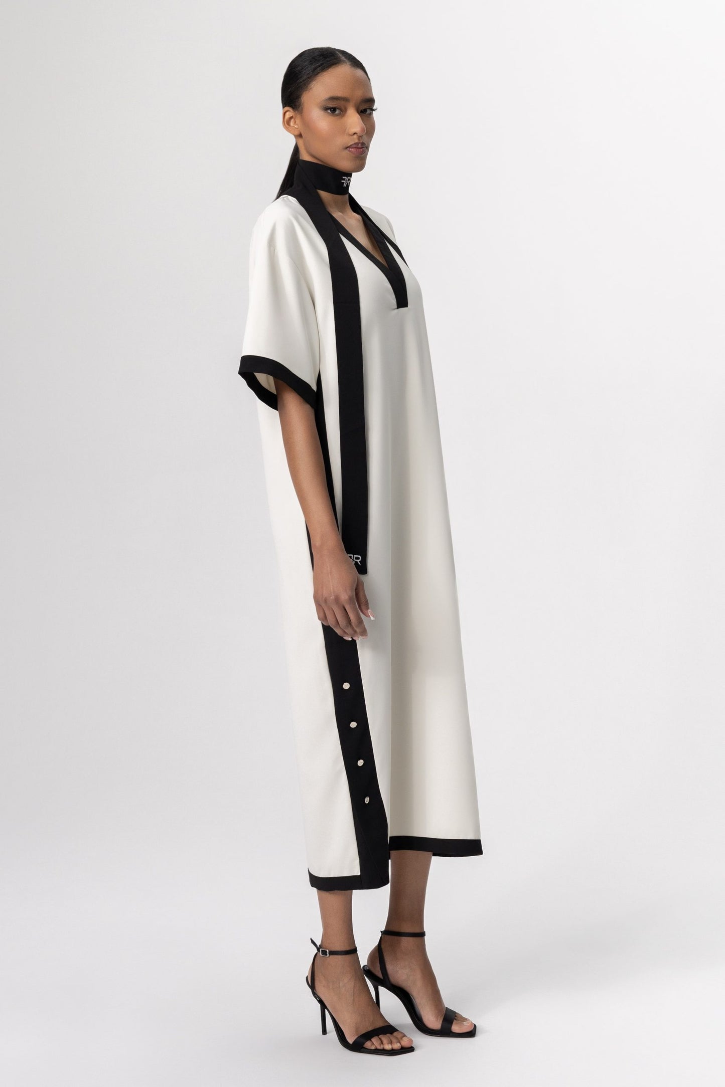 Discover the perfect harmony of contemporary elegance and sophisticated allure with Freisi Milk Color V-Neck Dress