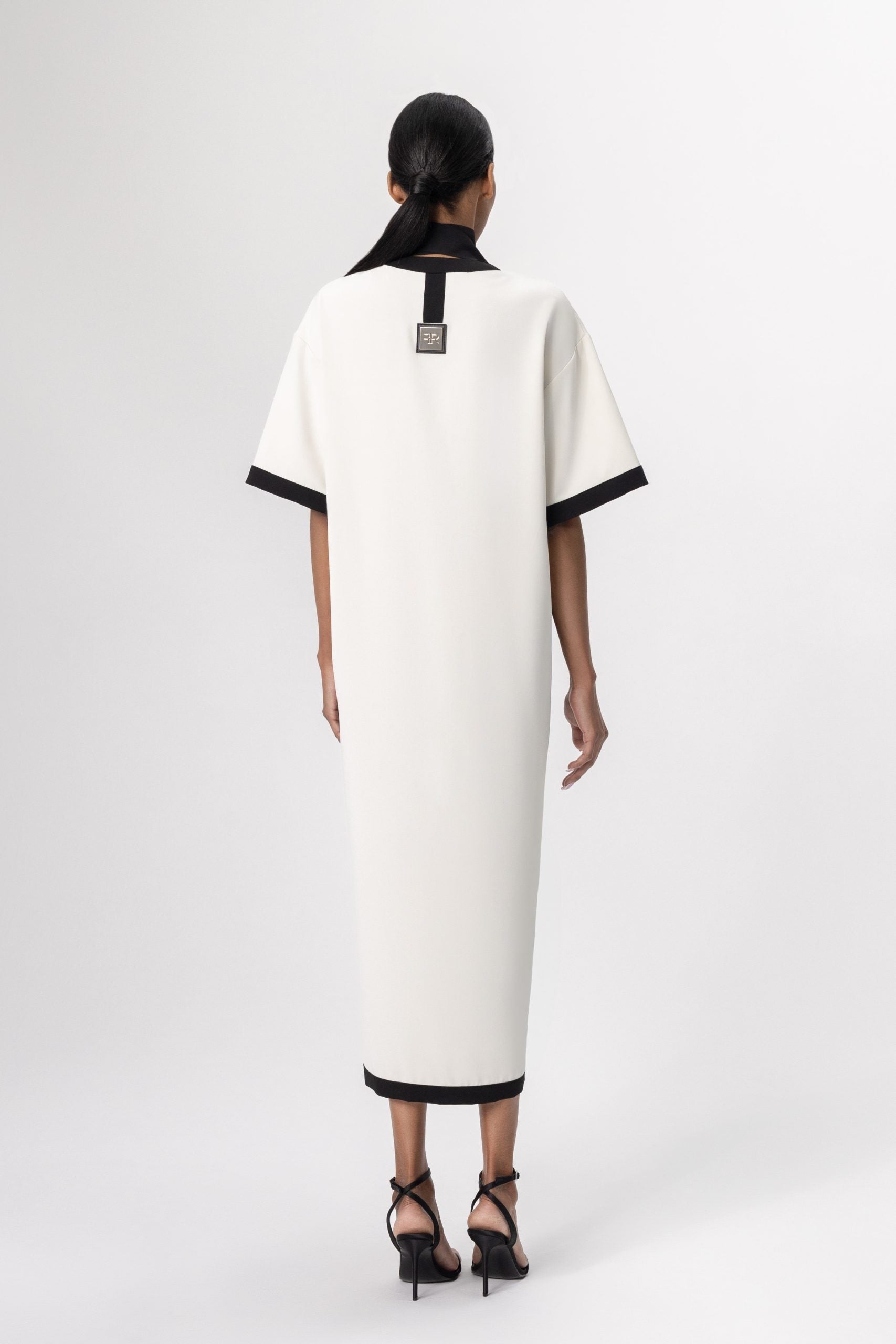 Discover the perfect harmony of contemporary elegance and sophisticated allure with Freisi Milk Color V-Neck Dress